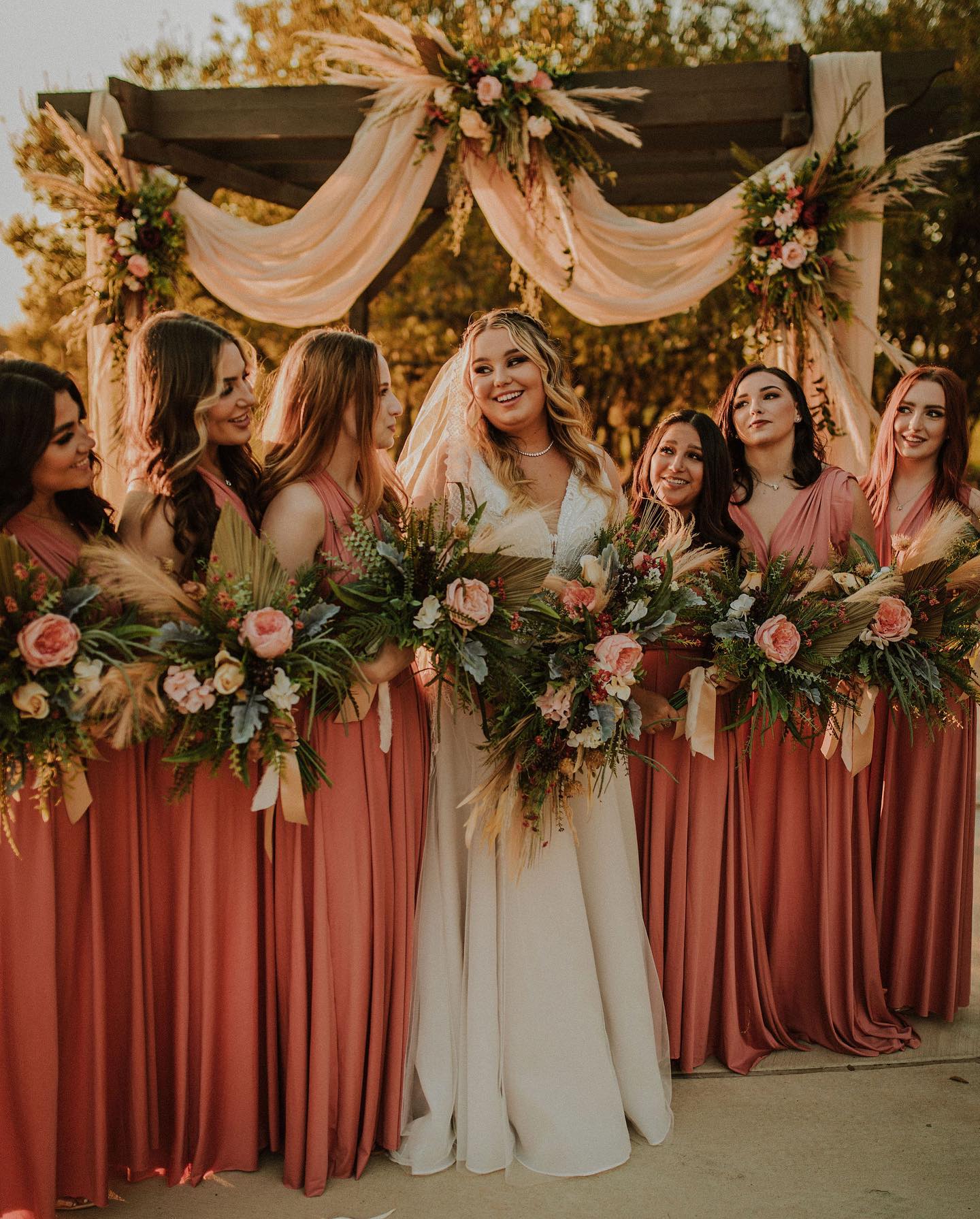 bride with bridesmaids in pink gowns