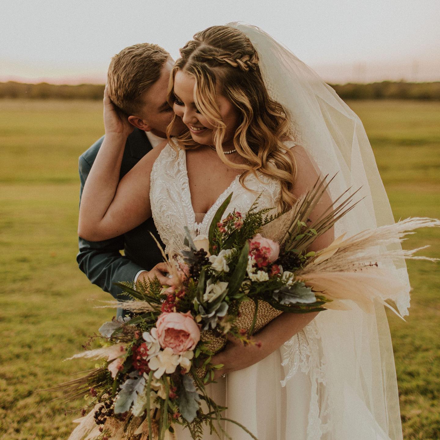 groom kissing bride on the cheek
