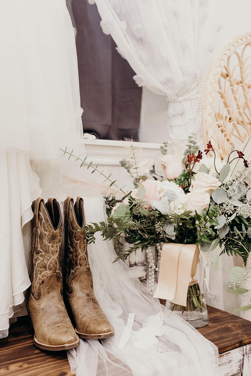 wedding dress with boots and bridal bouquet