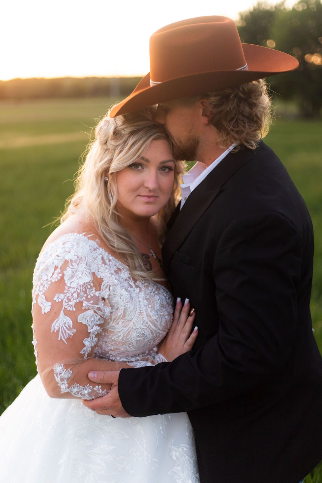 groom kissing bride on the forehead